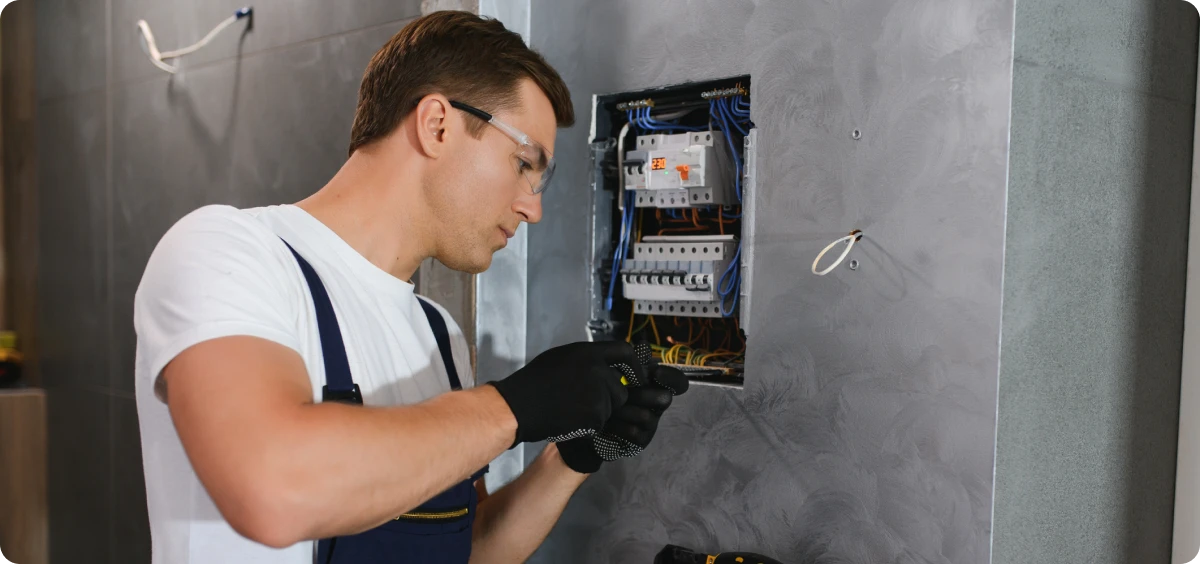 Technician repairing electrical box.